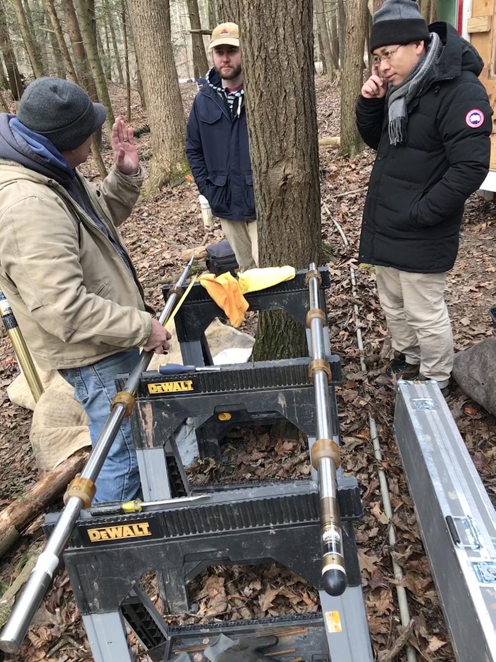 Researchers at the Shale Hills research site. Brad Carr, left, assembles tools to log a 115-foot deep borehole.