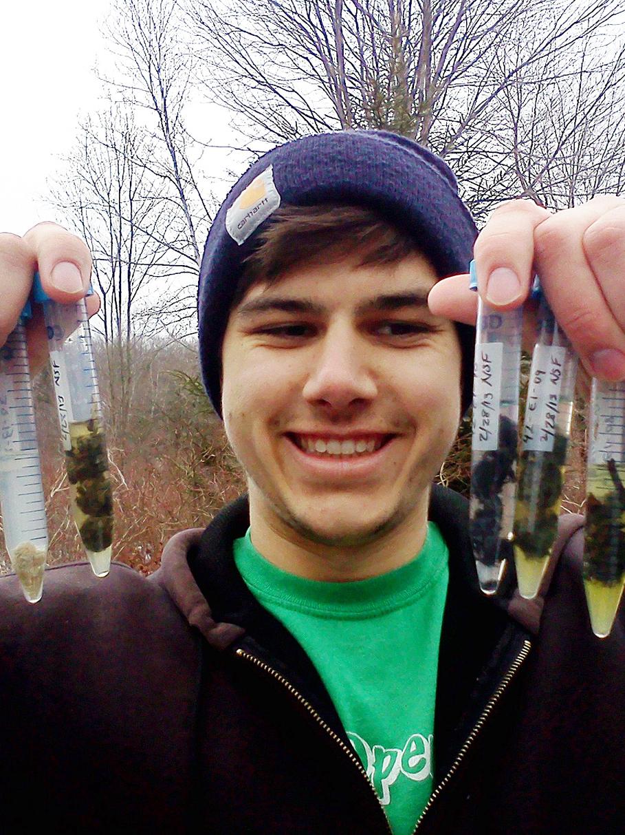 researcher with otter excrement