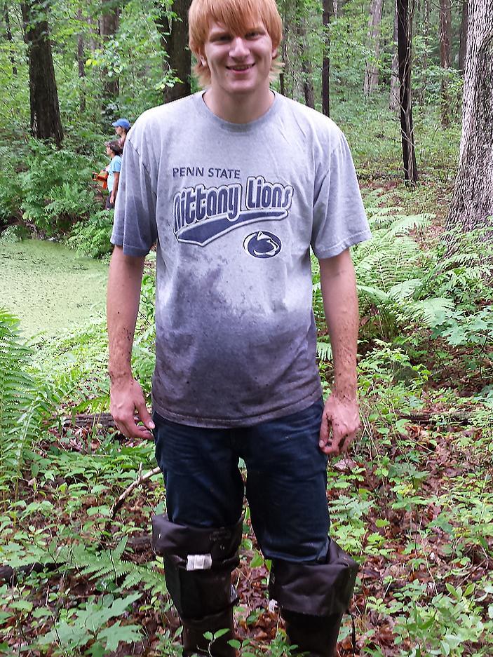 student standing in wetland