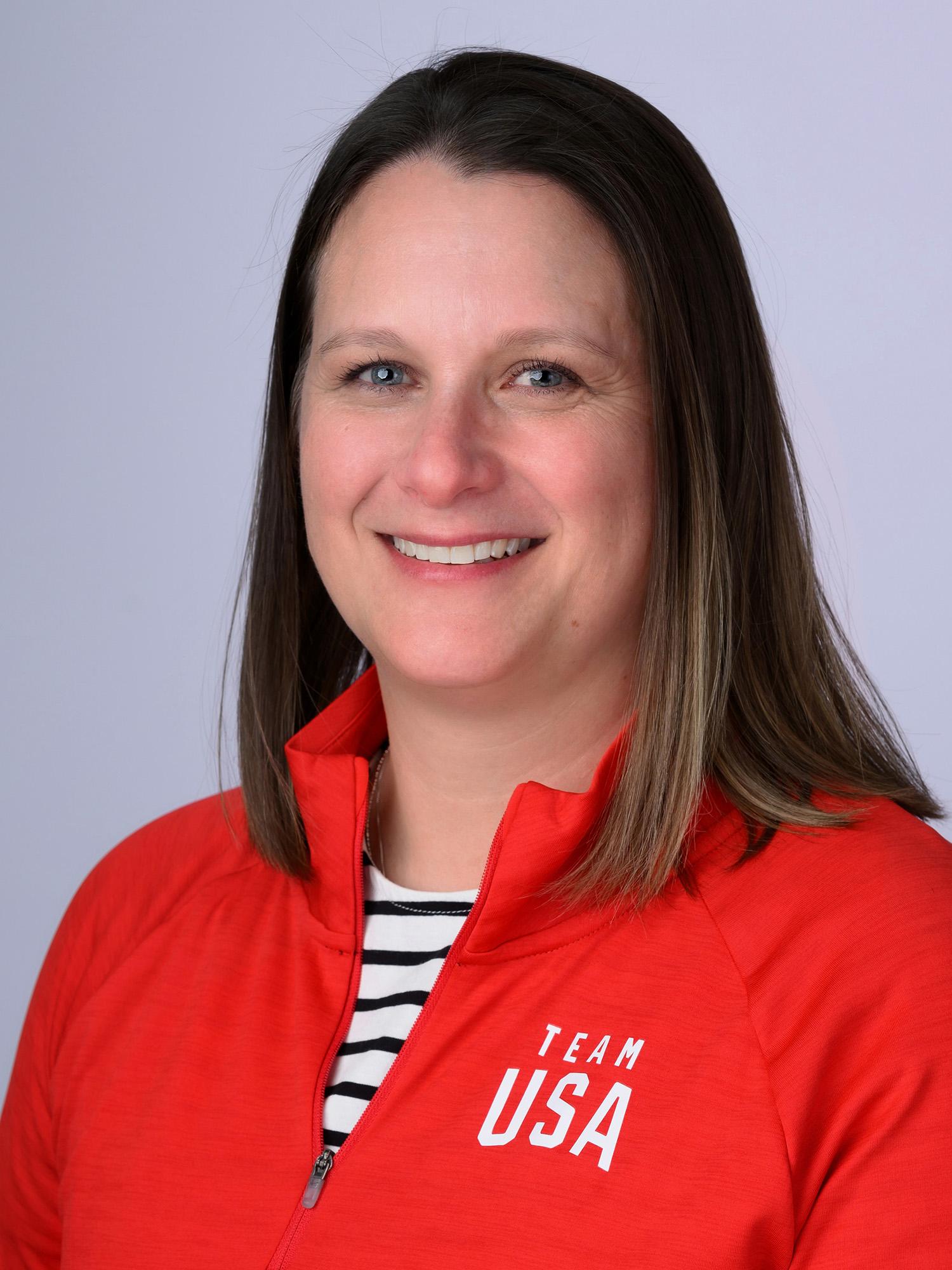 A headshot of a woman wearing a red Team USA jacket.