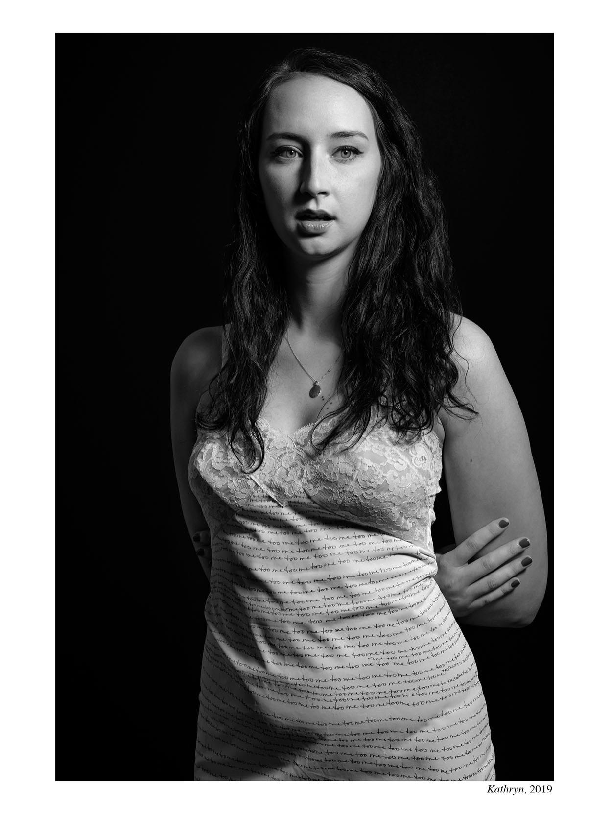 photograph of woman in clothing with writing on it