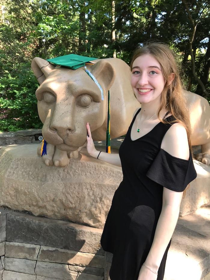 Taylor Hufnagel poses in front of the Nittany Lion Shrine