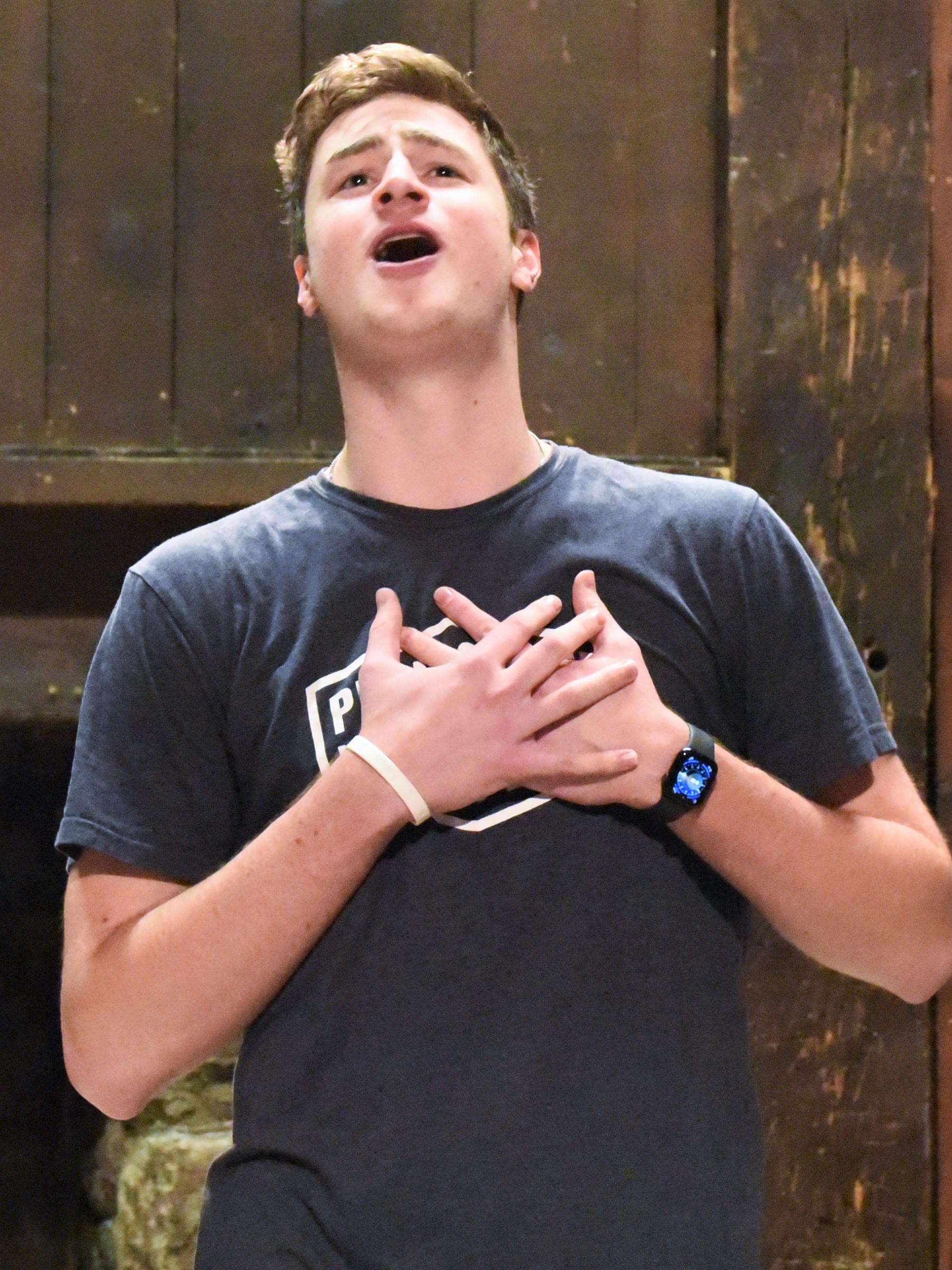 A male student sings a song from "Bright Star" during a rehearsal in Penn State Behrend's Studio Theatre.