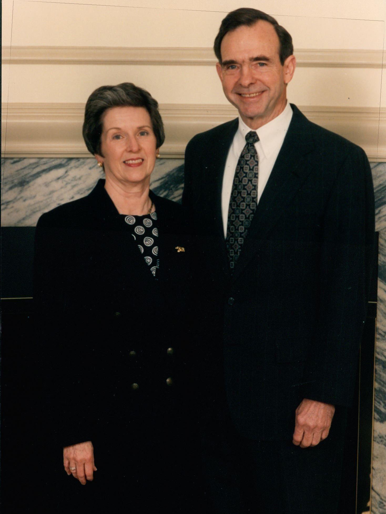 Marly and Joab Thomas stand in front of the fireplace in the president's office in Old Main