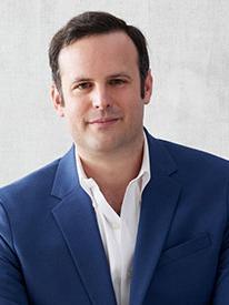 Max Crowley head shot with short, black hair, blue suite and white button down shirt