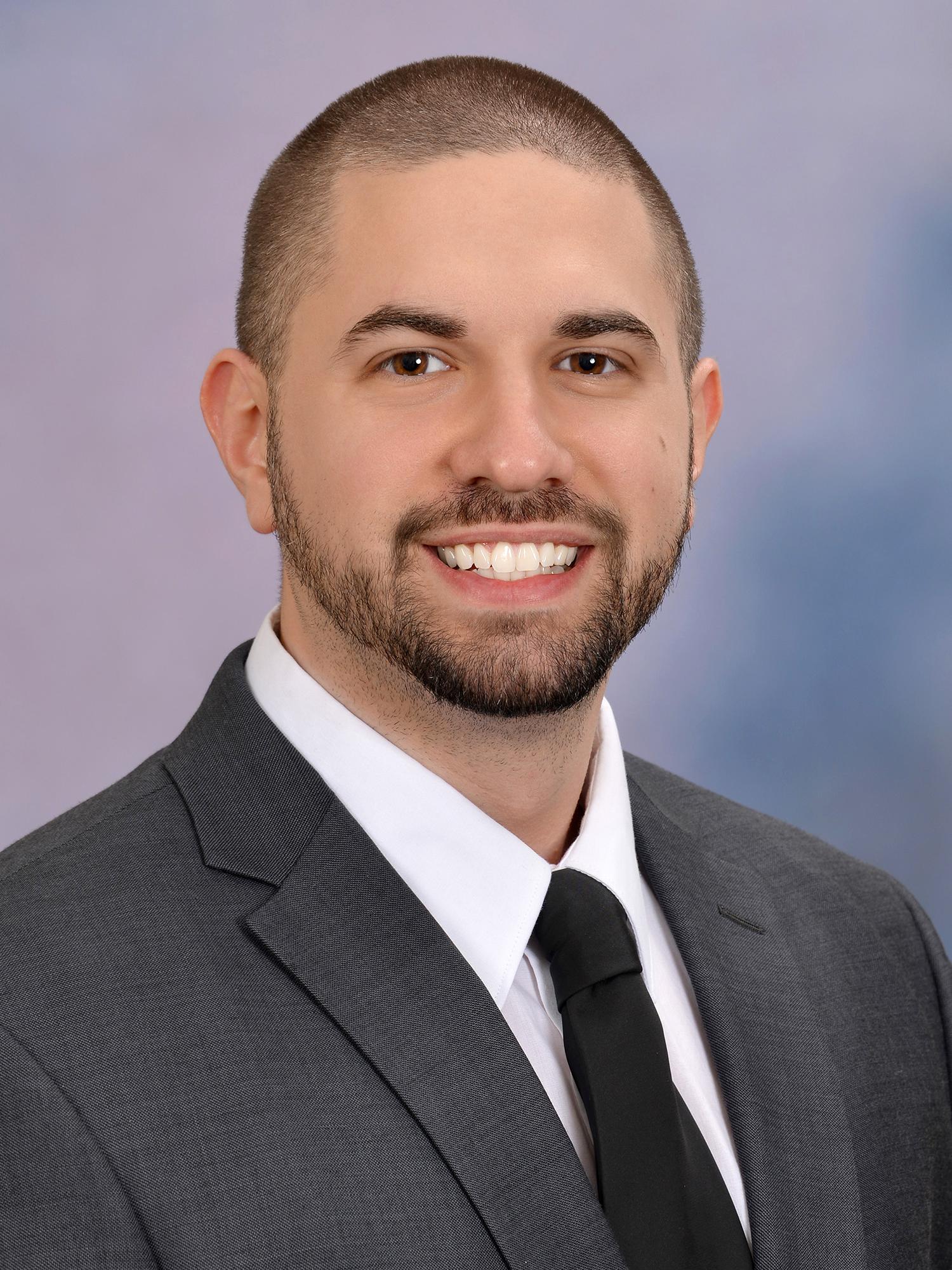 Head shot of man wearing suit and tie
