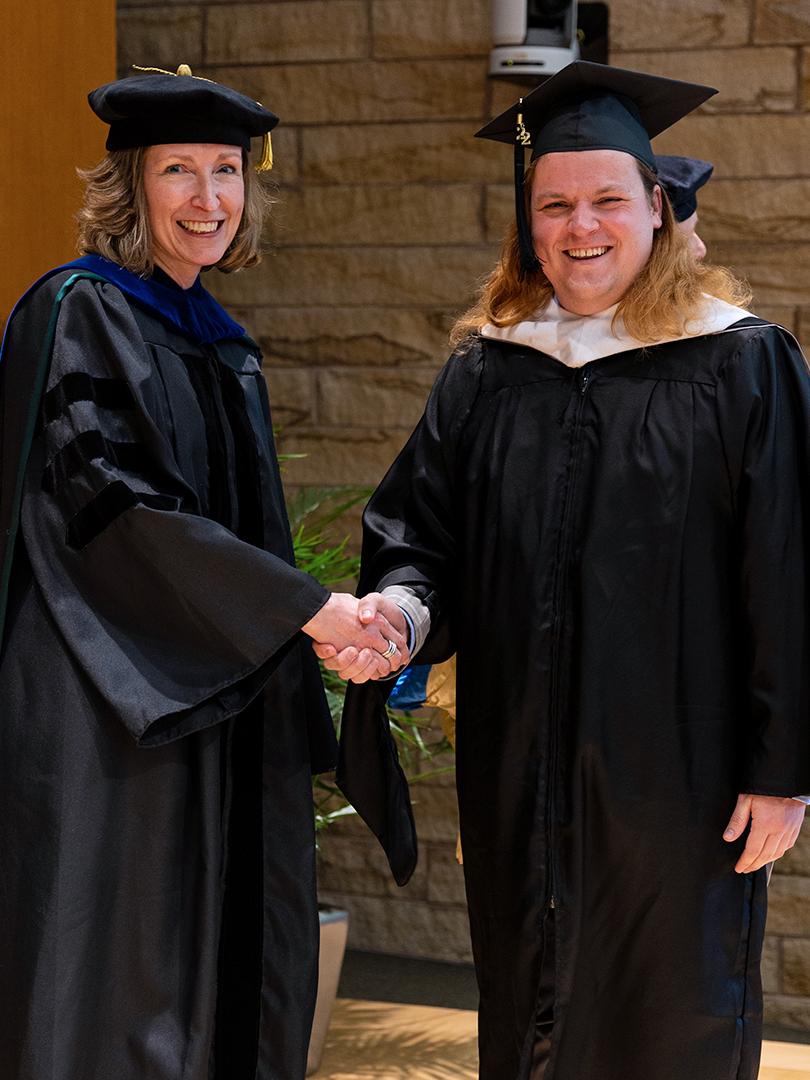 SIA Interim Director Elizabeth Ransom and graduate Adam VanGorder