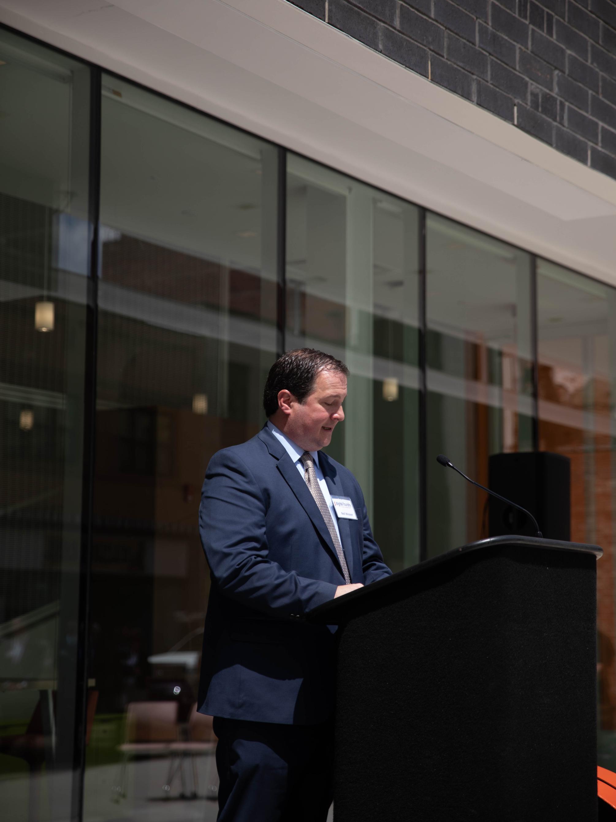 Man speaks at podium