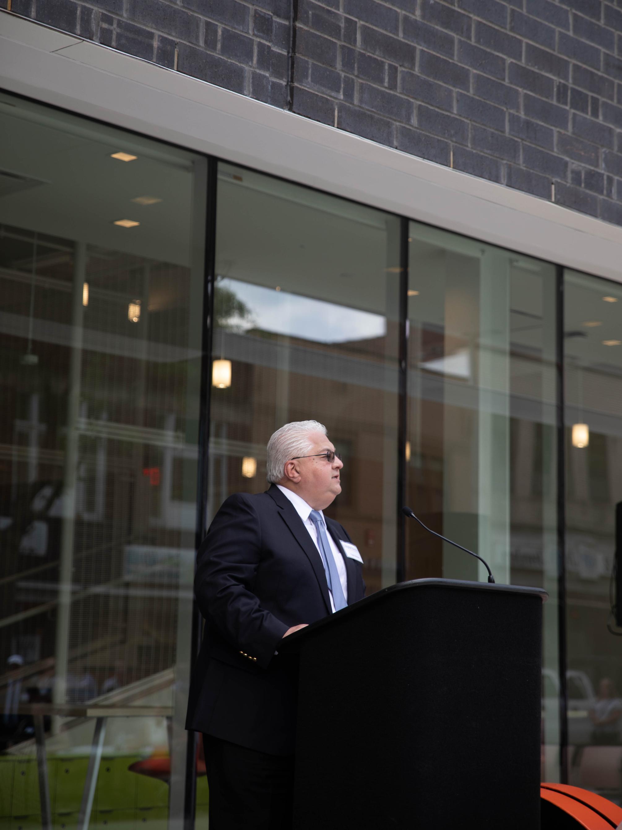 Man speaks at podium