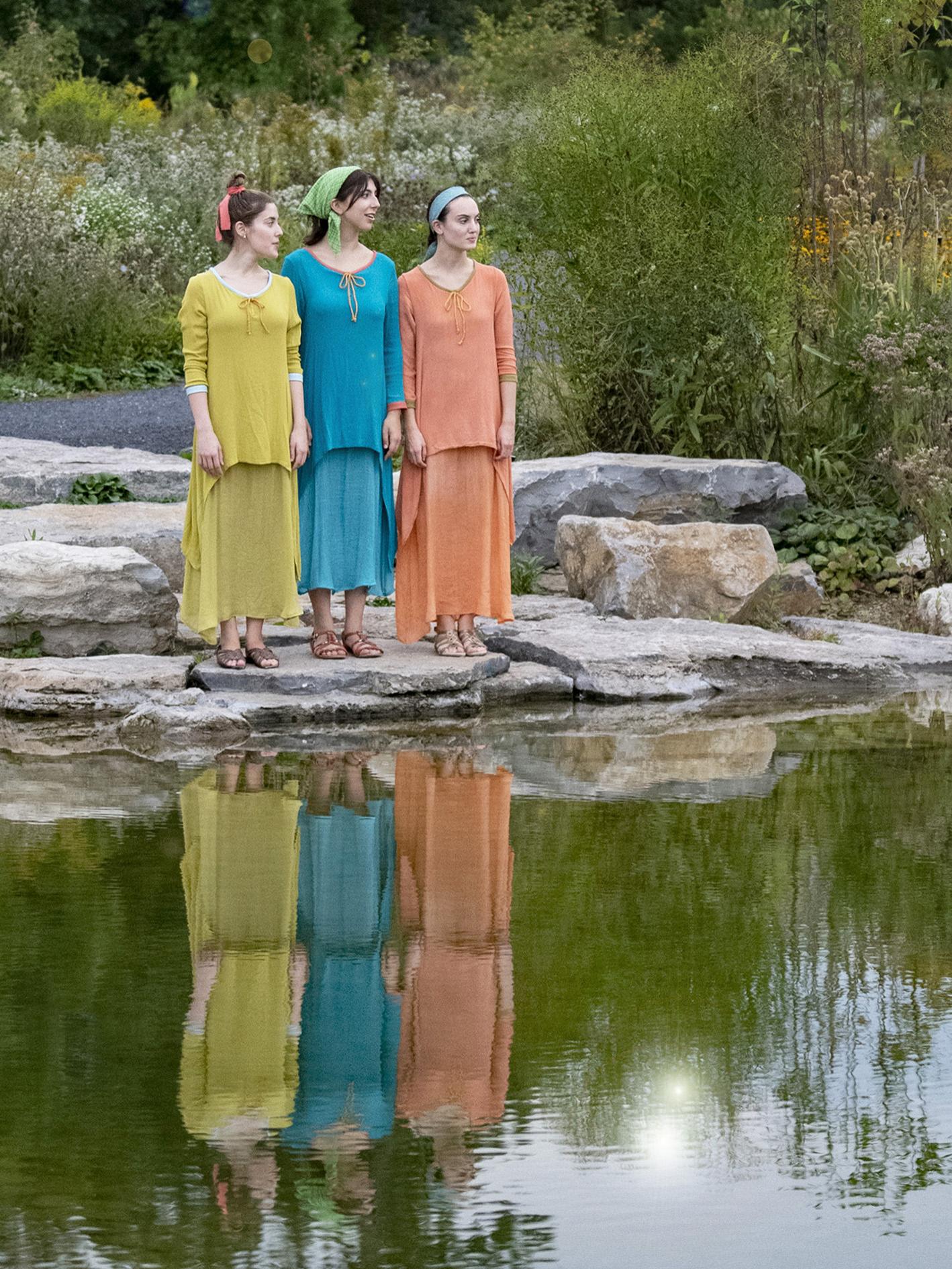 Cast of 'Metamorphoses' with reflection in water