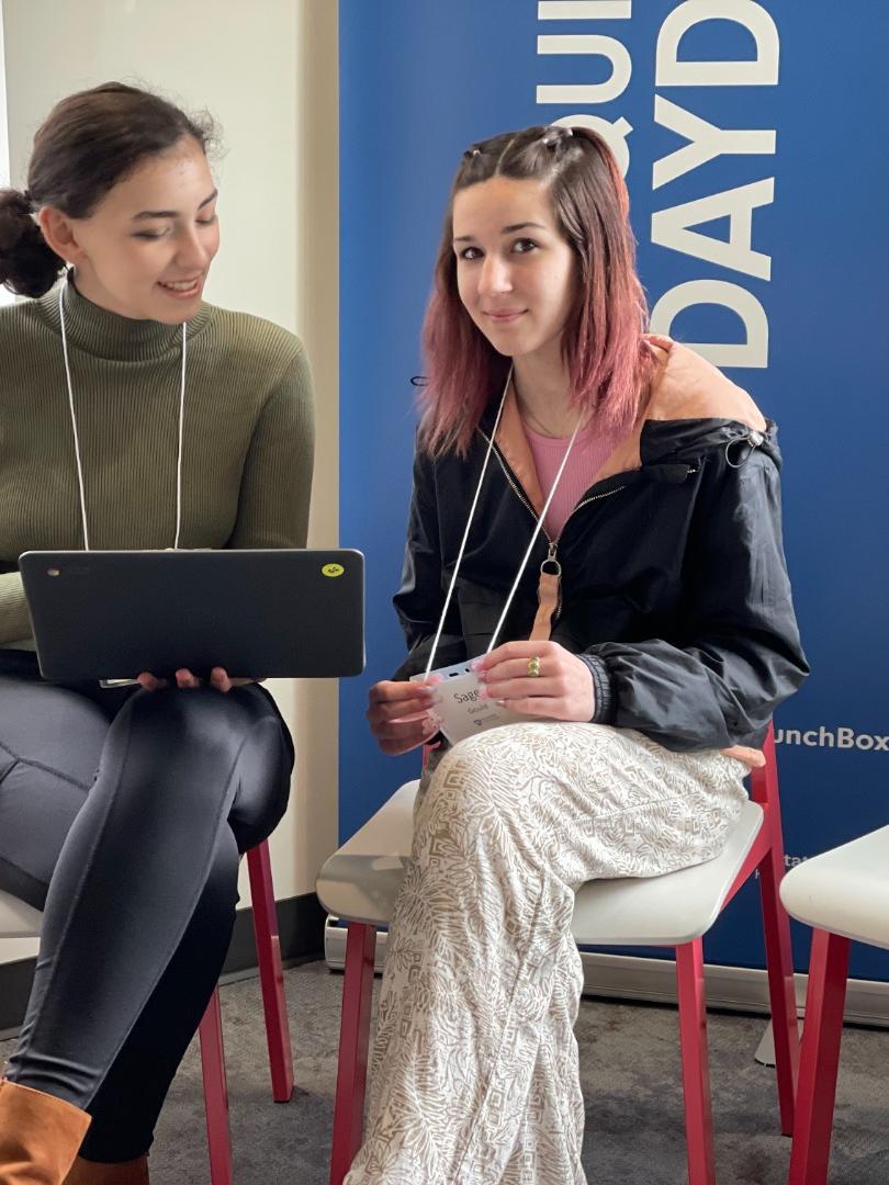 Two students looking at a computer.