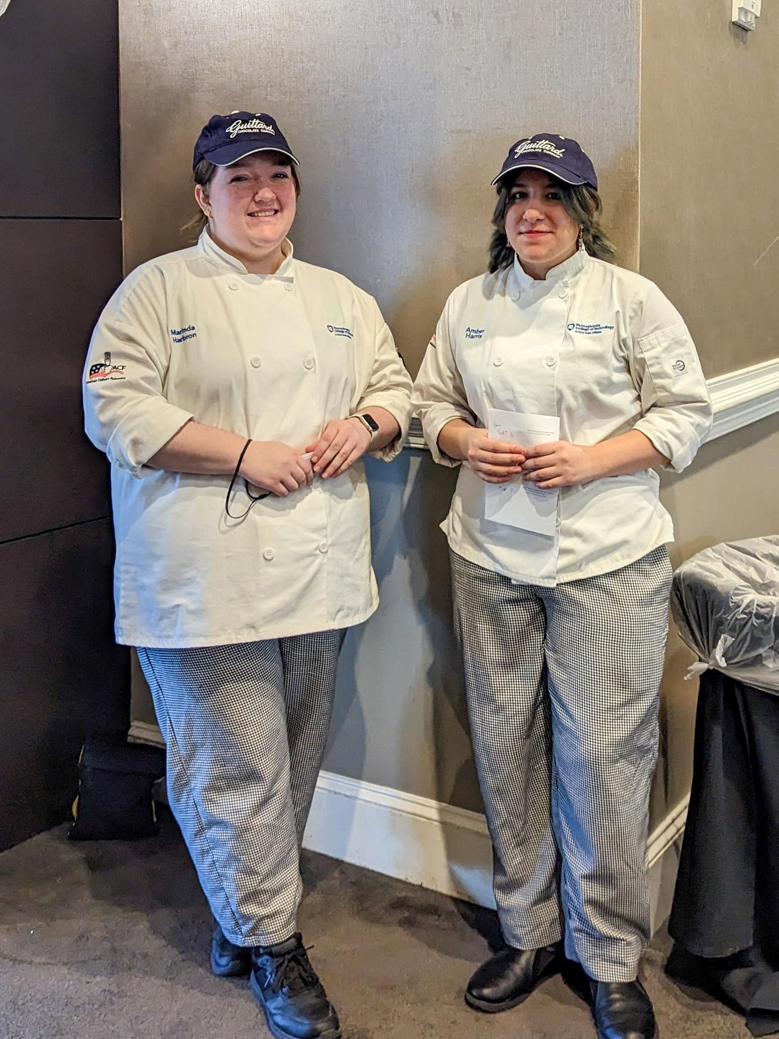 Two people wearing chef's uniforms