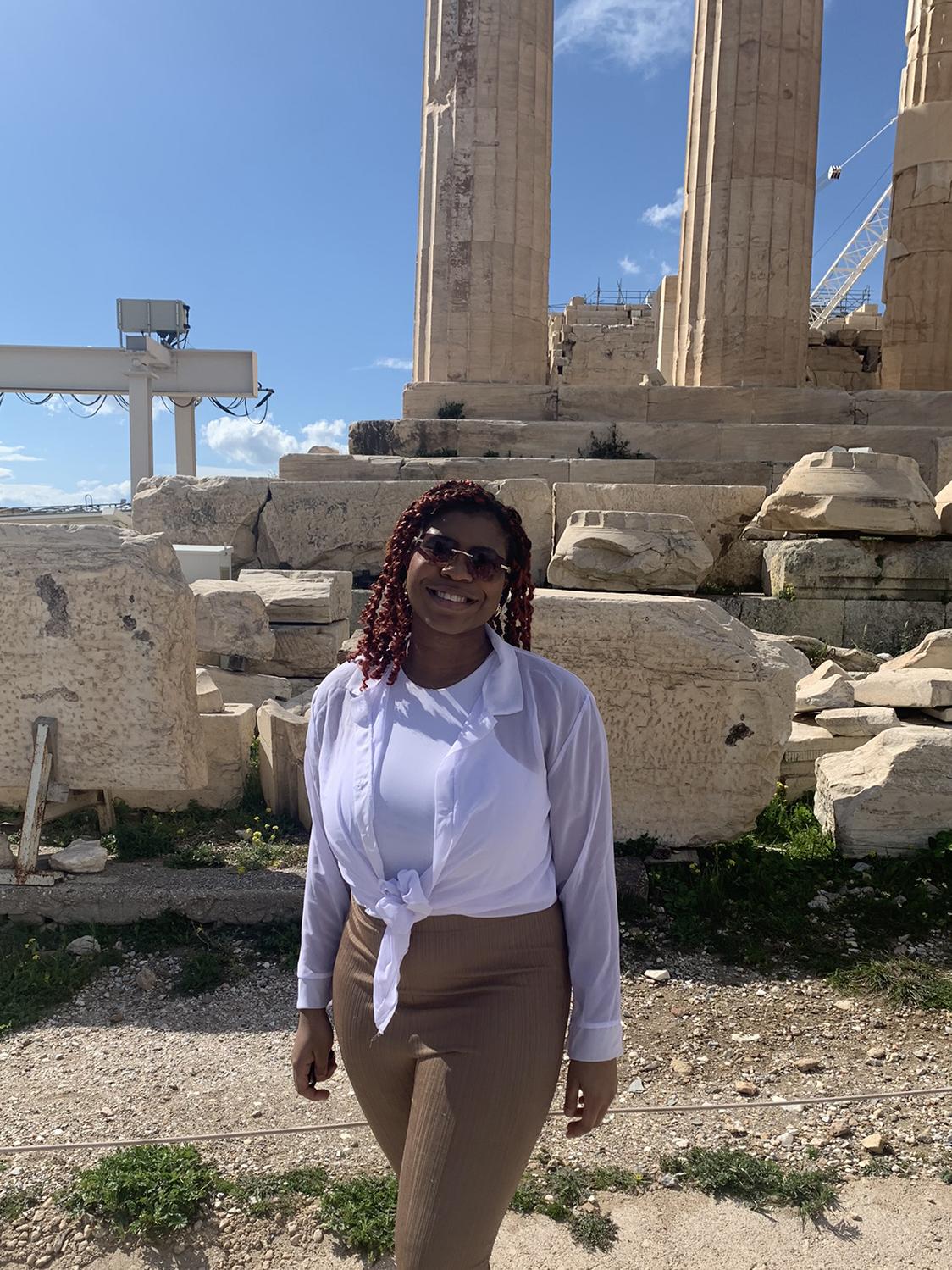Leila Filien stands in front of the Parthenon in Athens, Greece, during the daytime.
