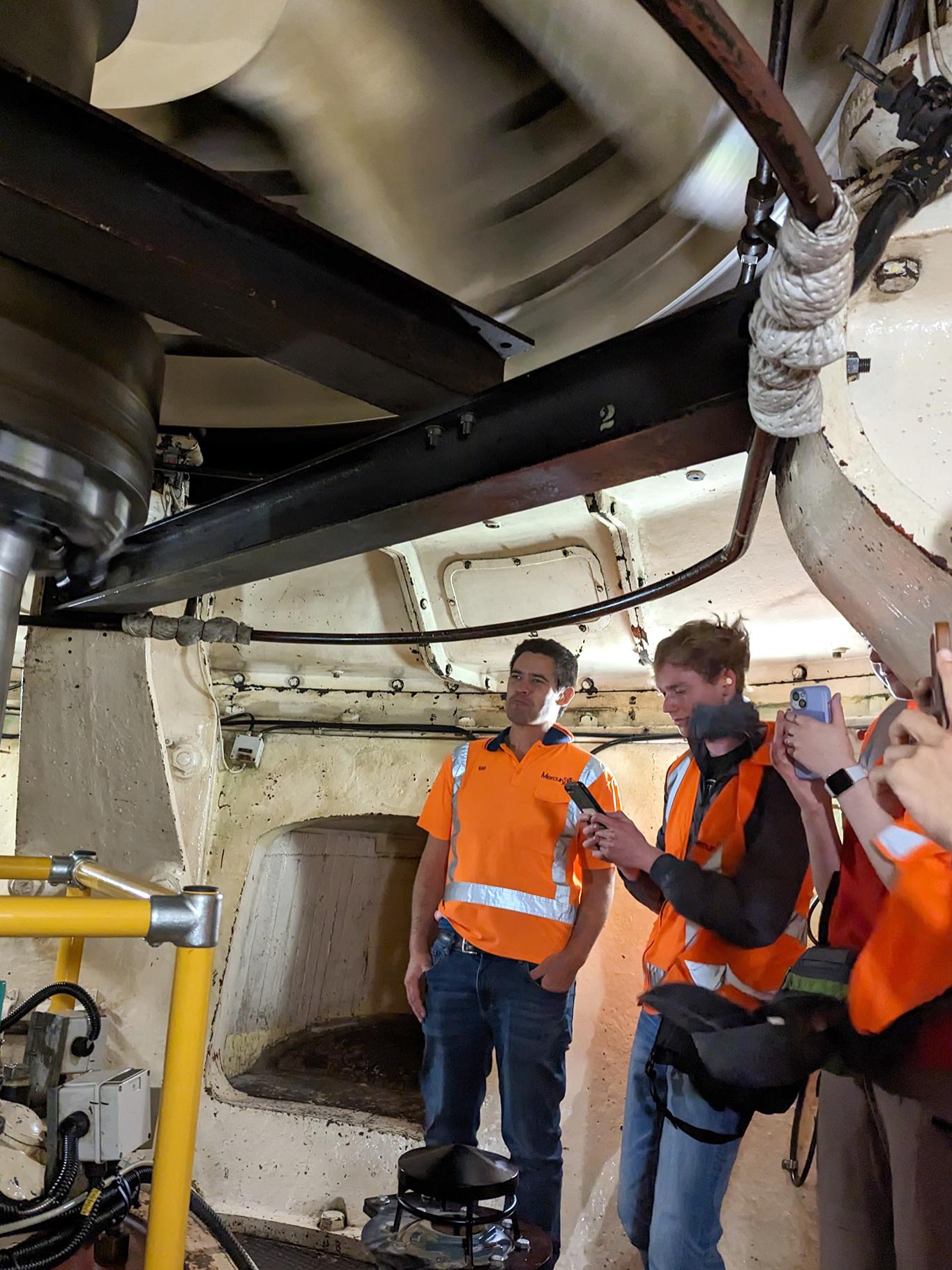 Students visit New Zealand's Arapuni (Hydro) Power Station as a fast spinning rotor is seen at left.