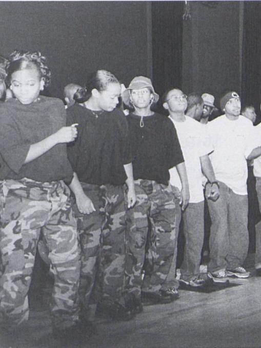 A group of students prepares to dance on stage