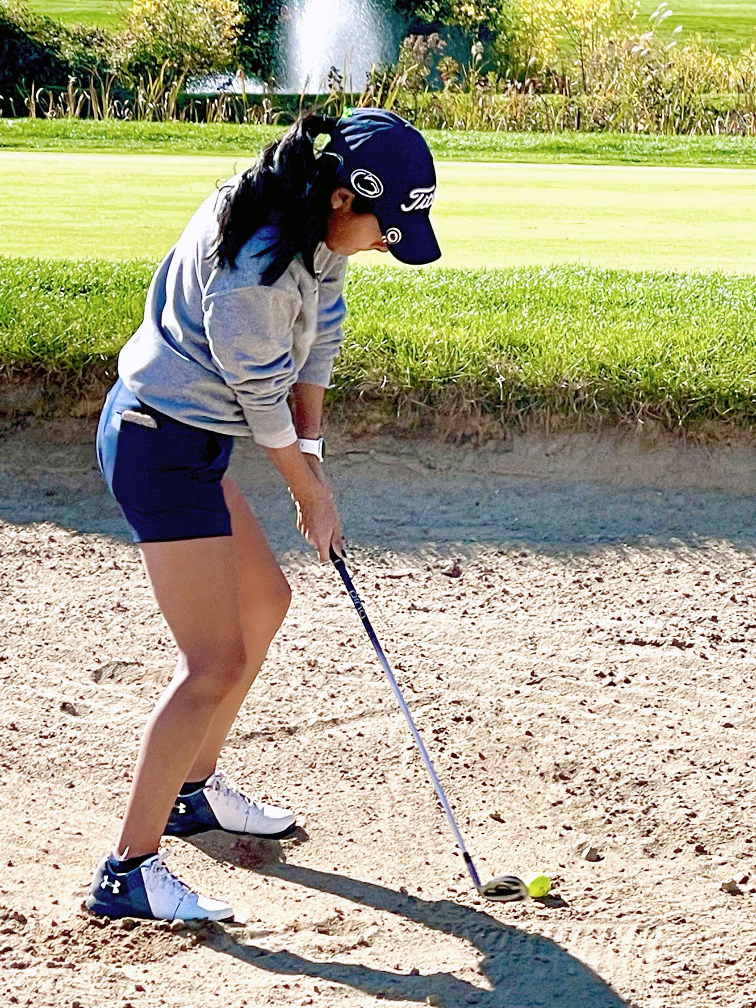 Gianna Effinite prepares her swing on a golf course.