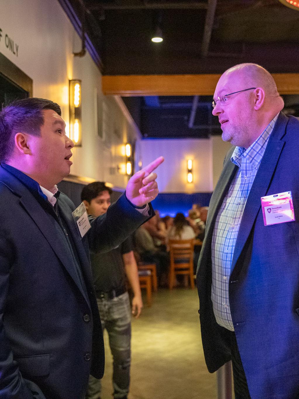 2013 alumnus Dalel Ismagulov (left) and 2011 alumnus Scott Hillkirk at the alumni reception.