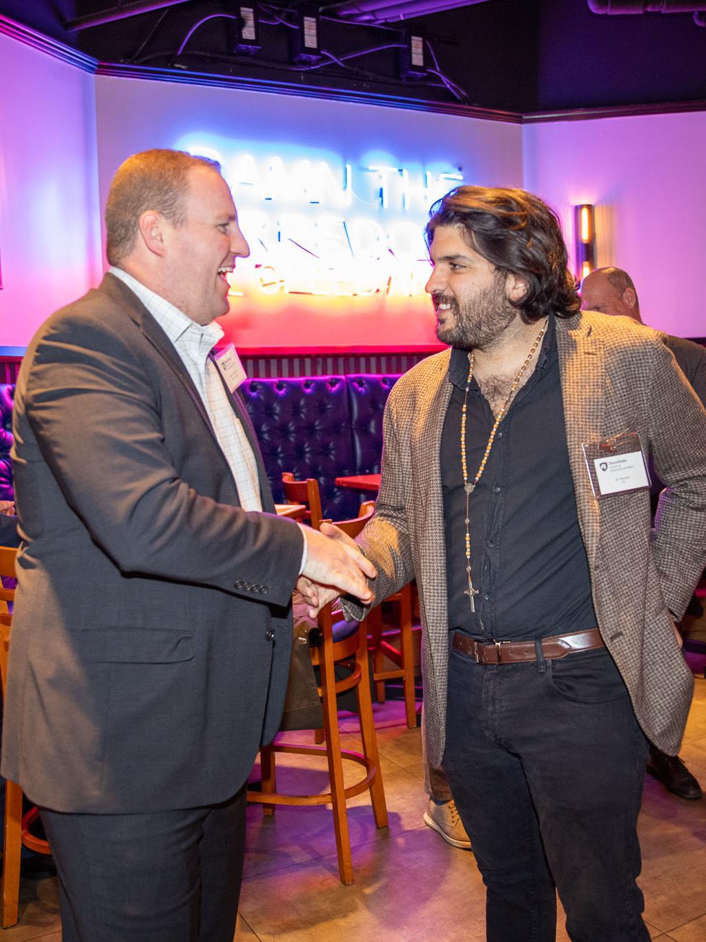 Master's certificate student Barrett Beaumont (left) meets 2023 alumnus Ian Tennison at the reception.