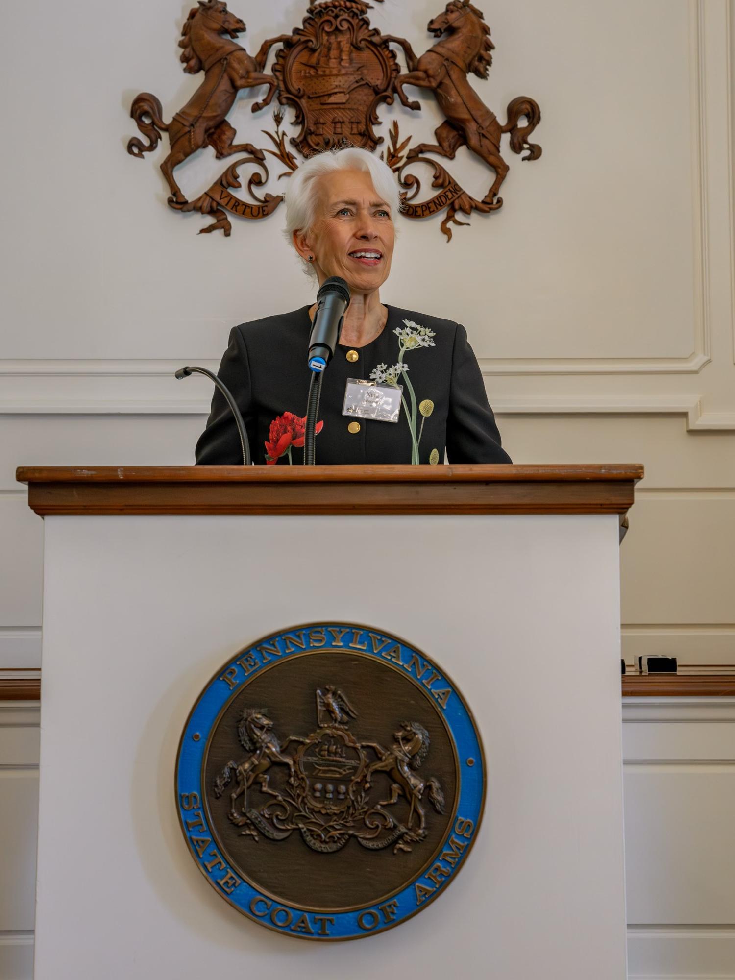 Nina Jablonski speaks at podium 