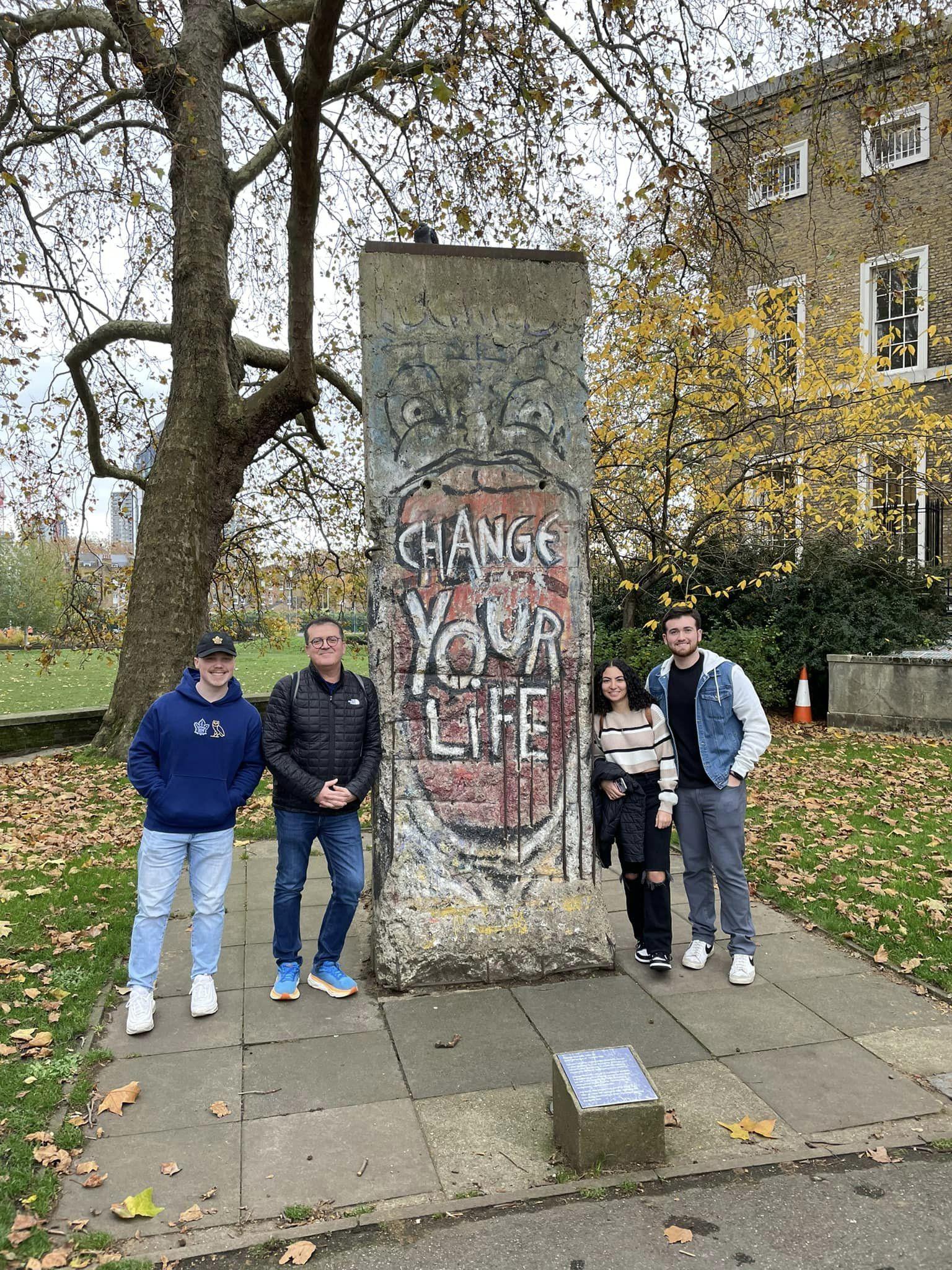 Students of the course CRIMJ 499 Serial Killers and European Criminal Justice next to a piece of the Berlin Wall.