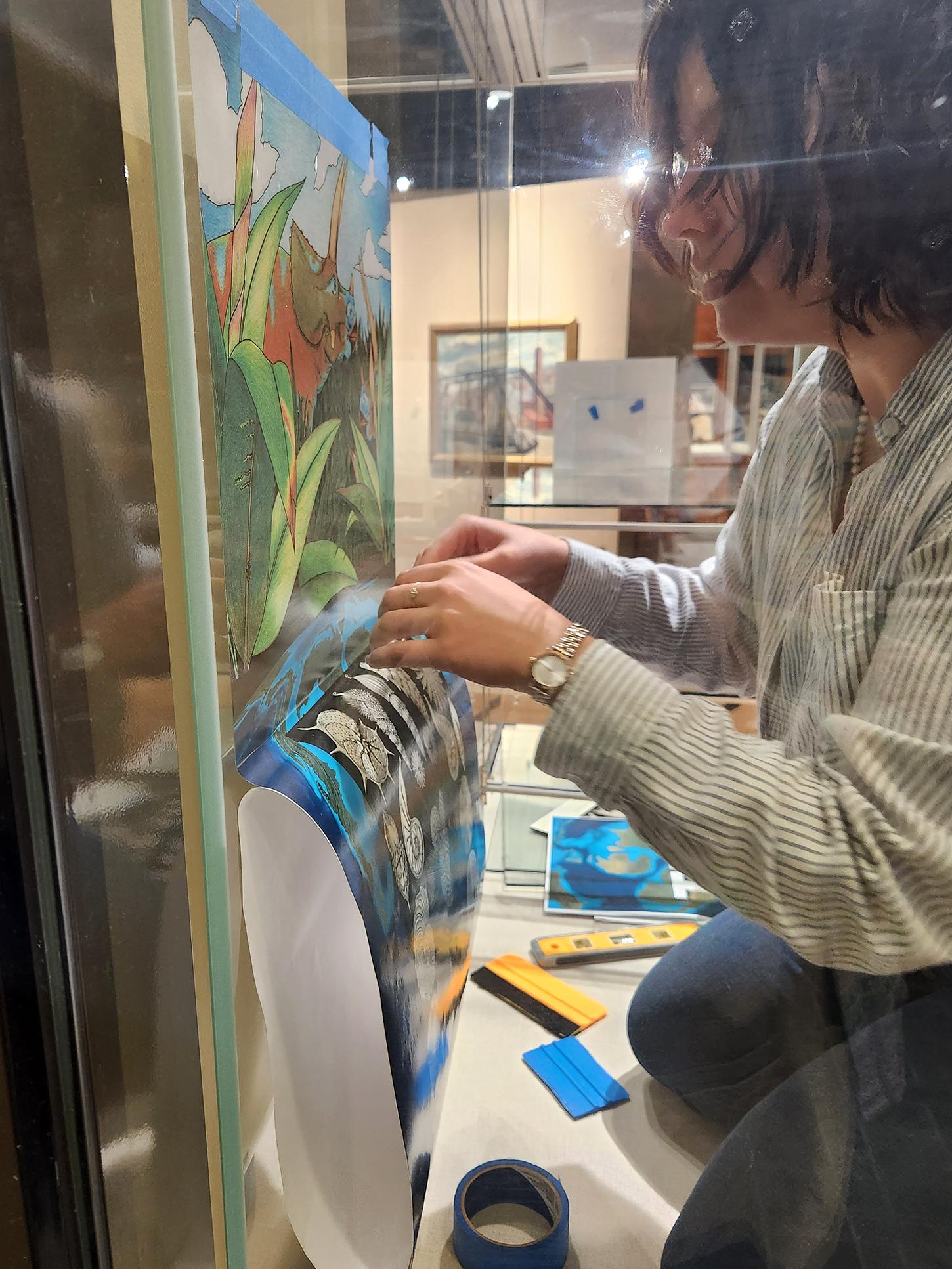 Kaitlyn Horisk works on the exhibit 