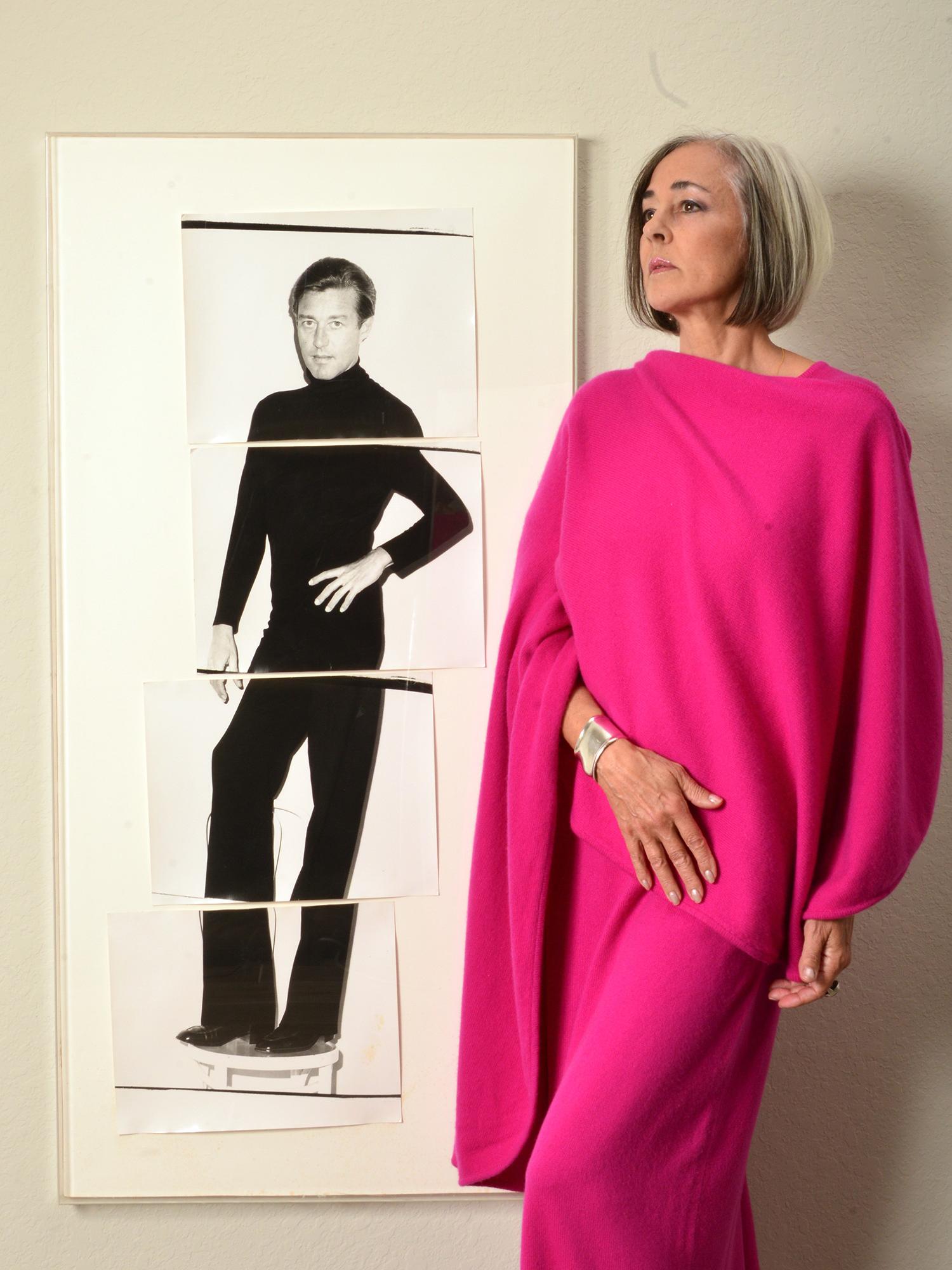 Lesley Frowick posing with photo of Halston