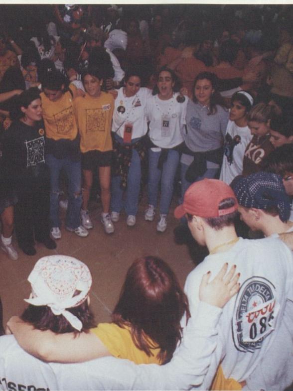 A group of dancers and supporters form a circle