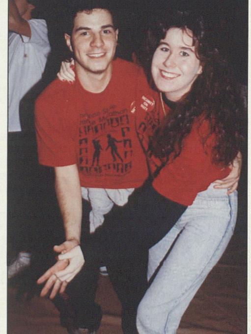 Two students pose for the camera while dancing