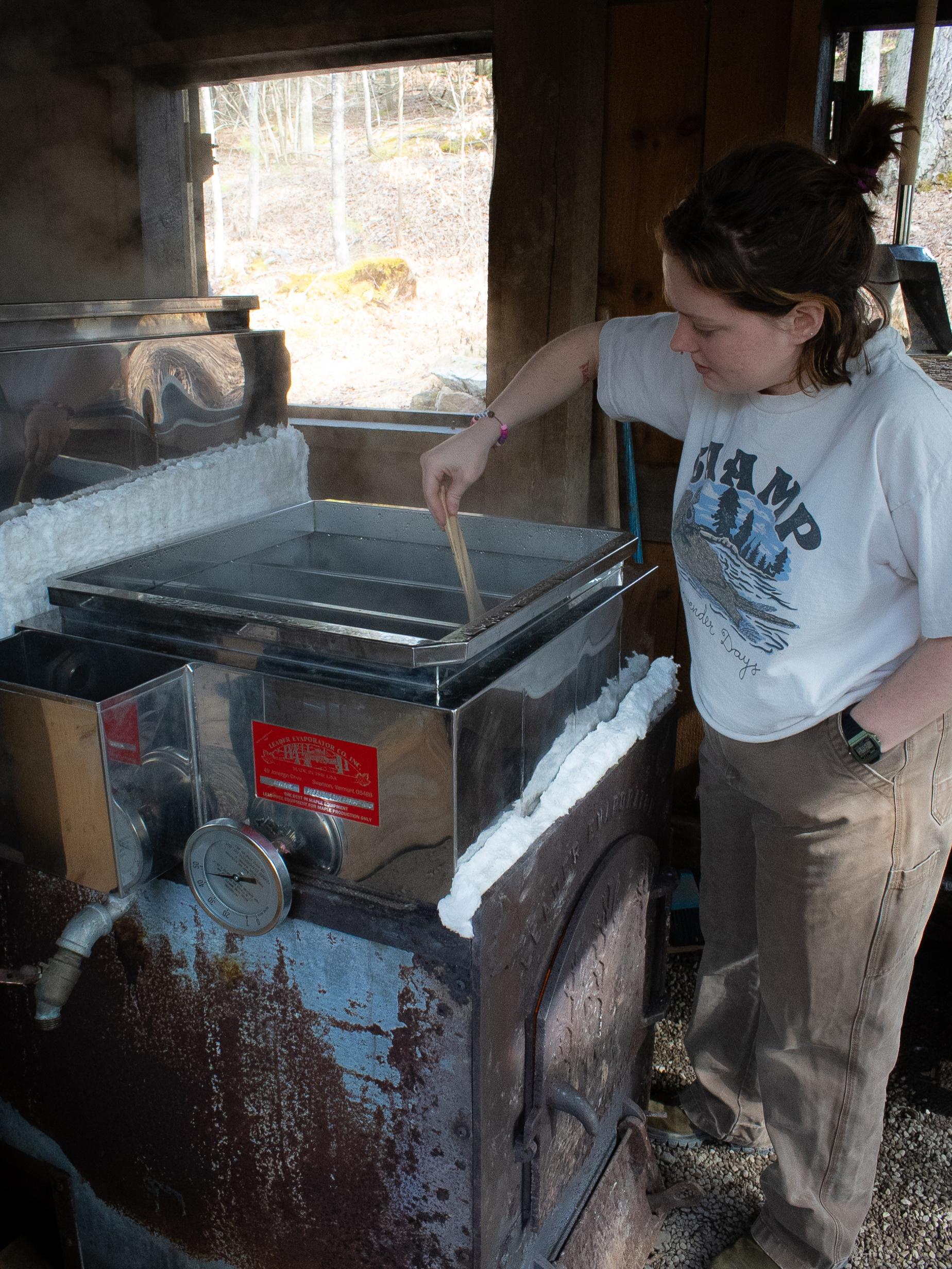 Intern makes maple syrup in large evaporator
