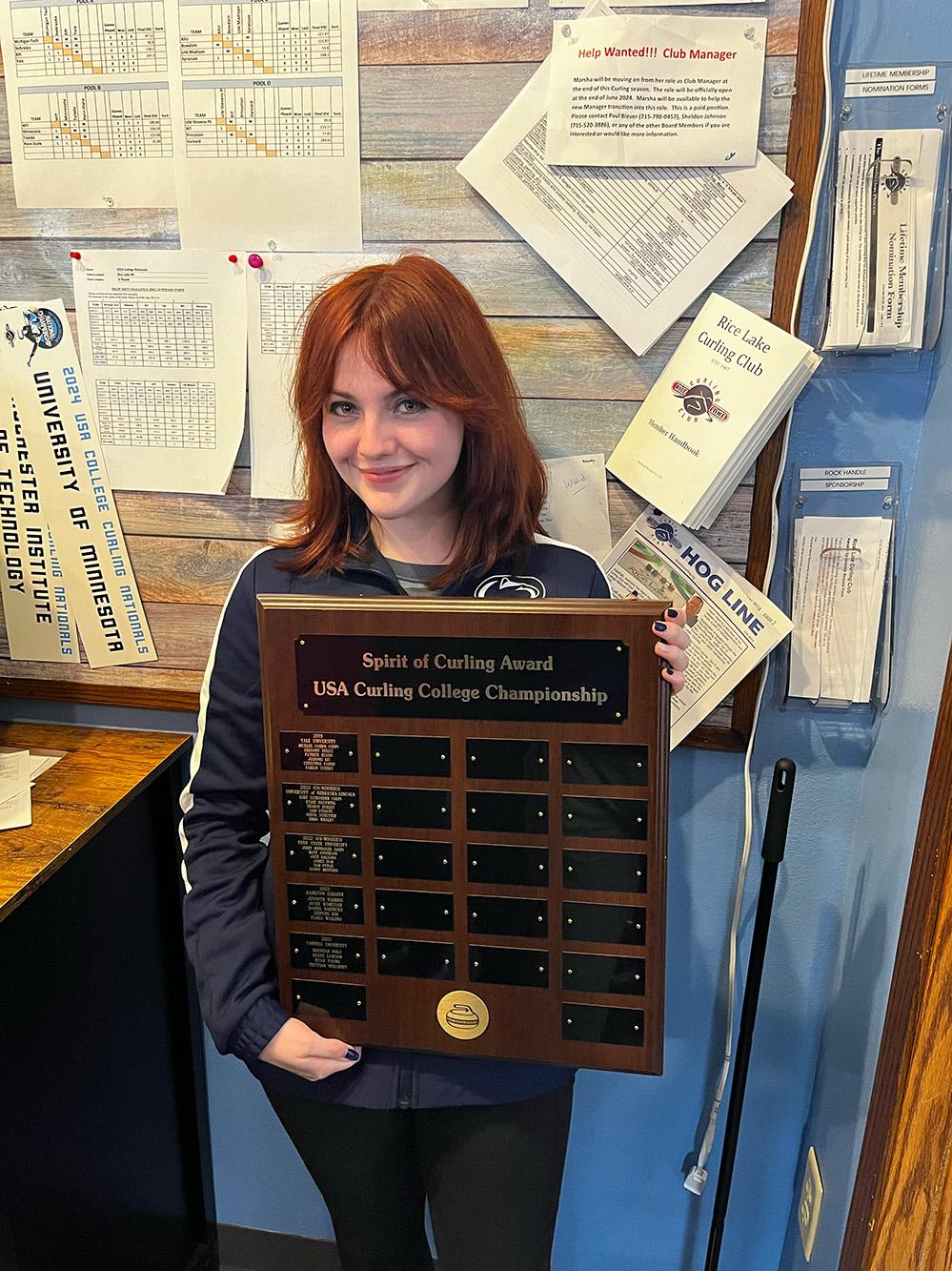 mallory wickline holding an award plaque