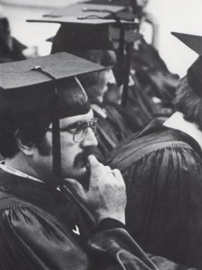 A graduate wearing a cap and gown