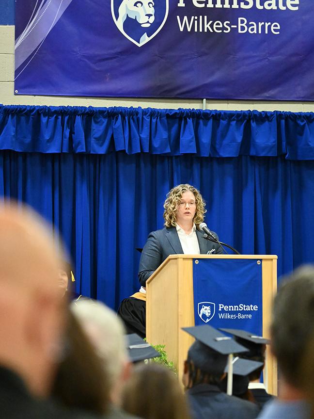 A woman speaking from the podium.