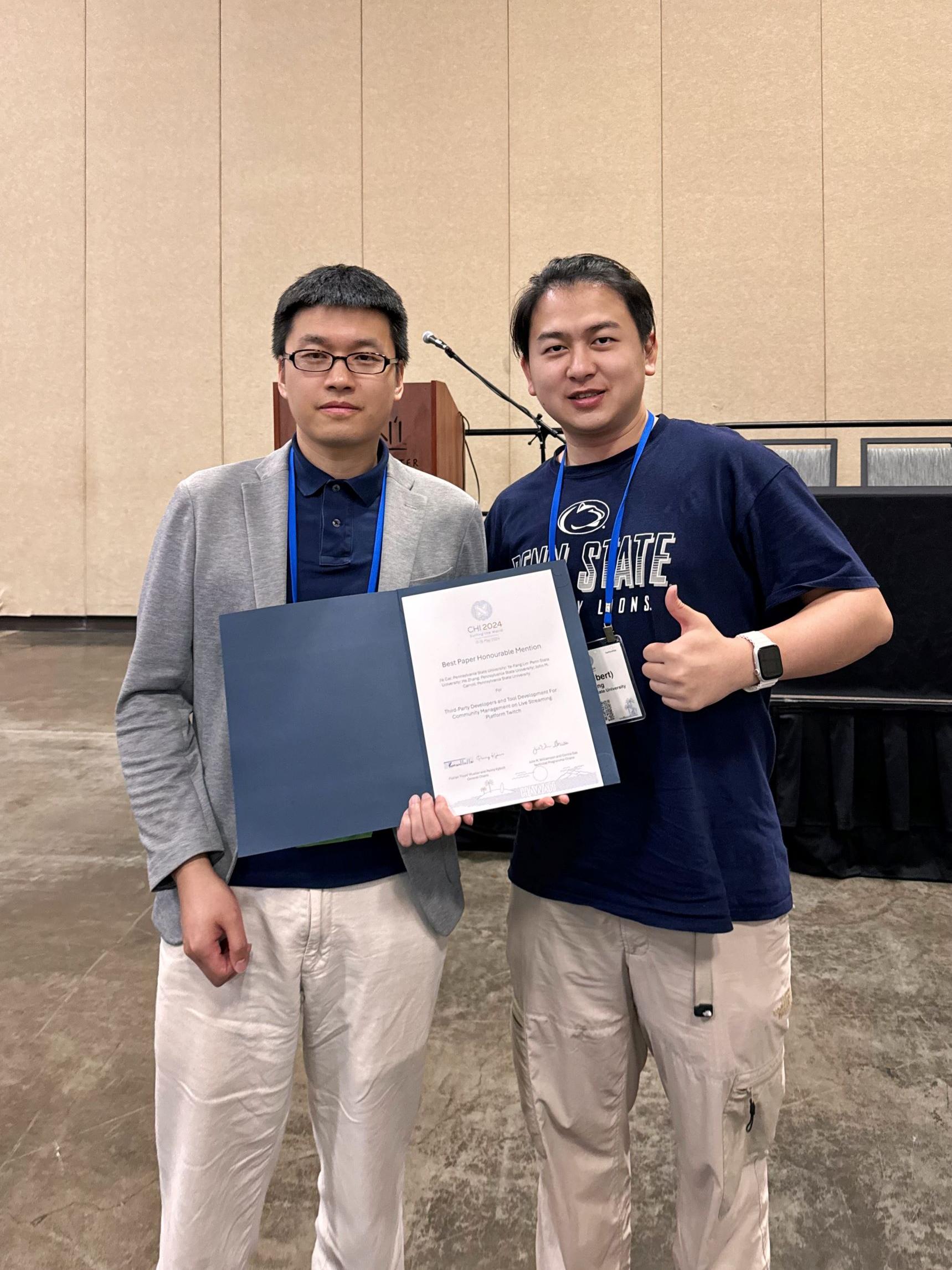 two people with winners certificate