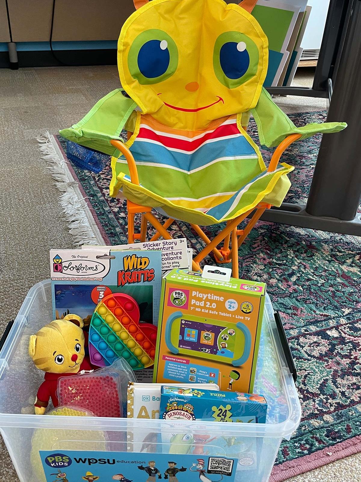 children's caterpillar chair and toys in a bin