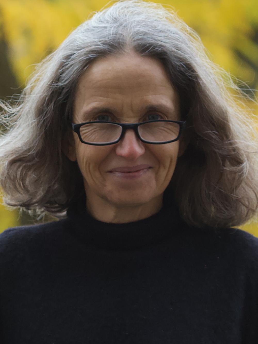 Woman with glasses and long graying hair