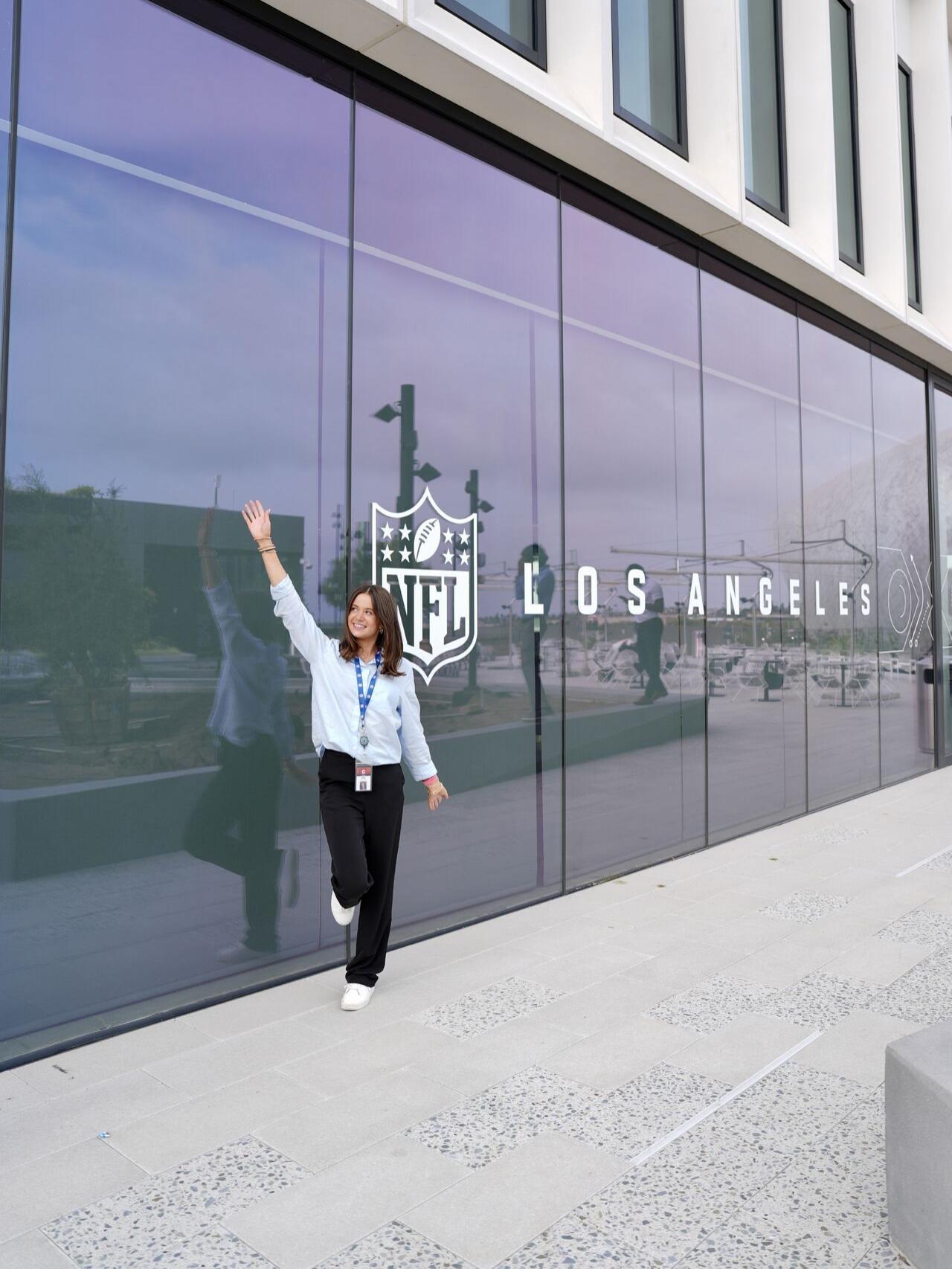 A student poses next to an NFL Los Angeles sign