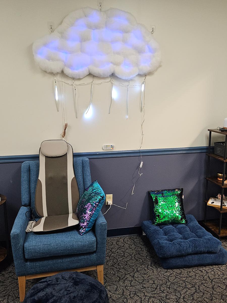 A massage chair with a zen sand garden and cushions next to it