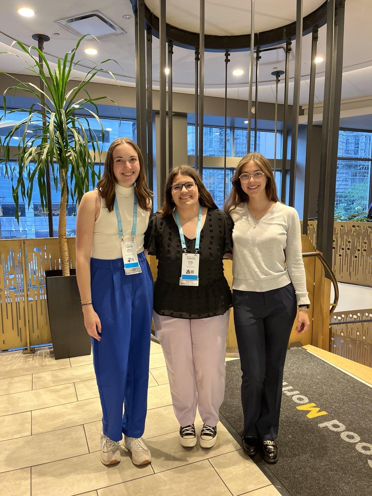 three young adults wearing lanyards