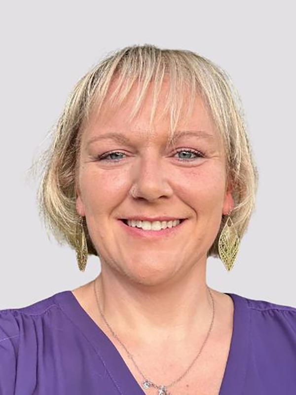 A headshot of a woman with blonde hair.