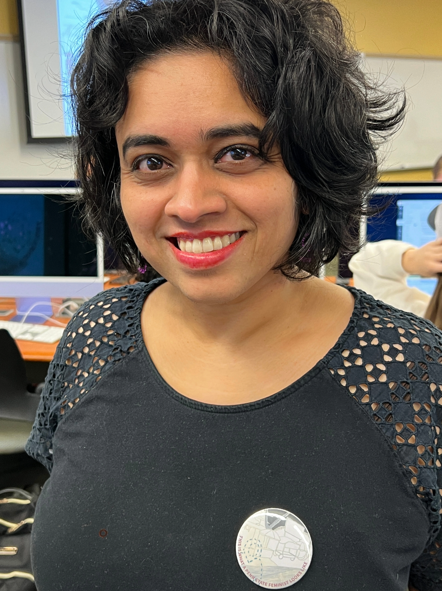 WMNST106 instructor Aparna Parikh displays her button.