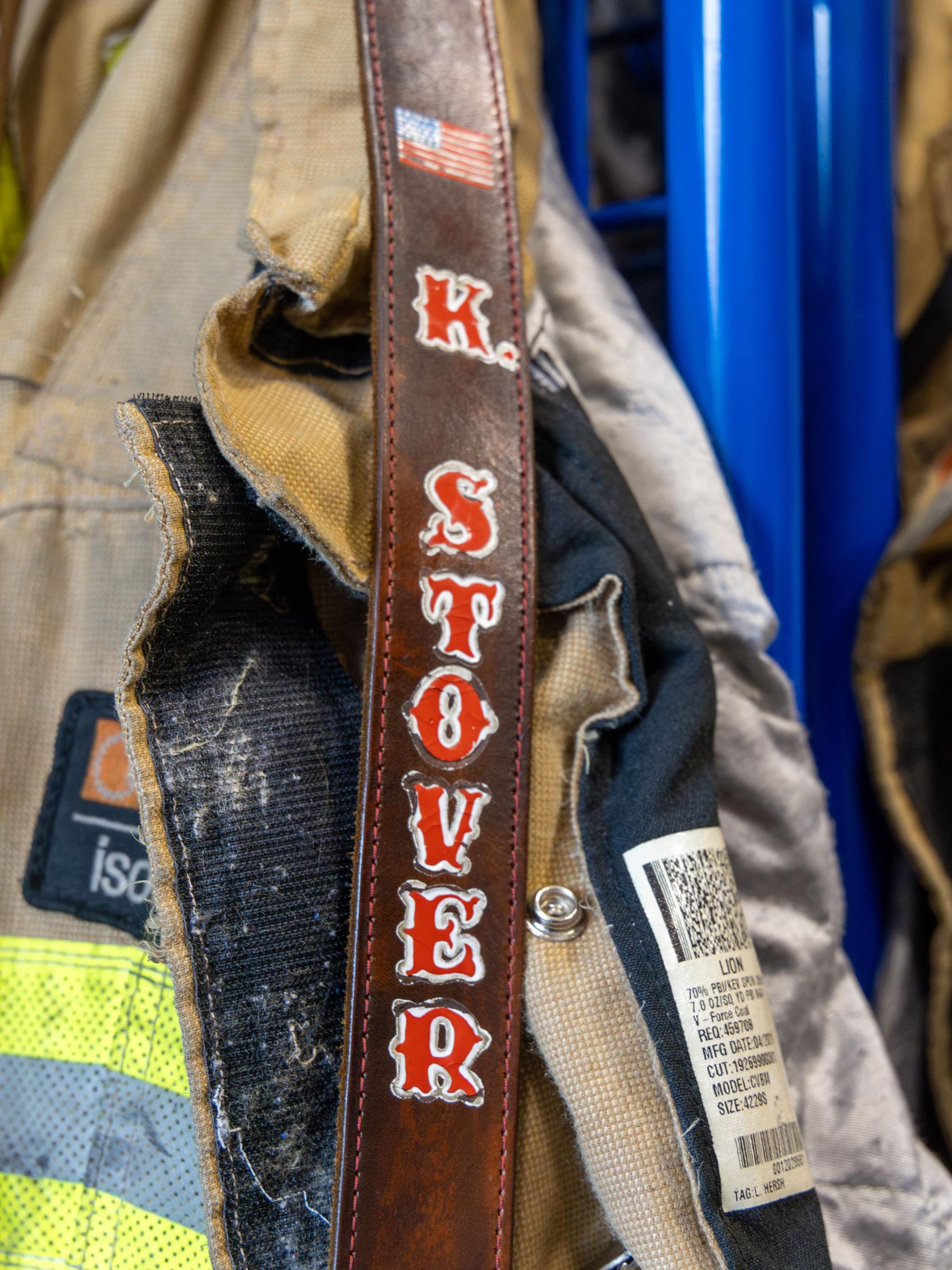 Kara Stover’s crossbody radio strap, which has the American flag and “K. Stover” embroidered on it in red, lays on top of Stover’s firefighter coat.