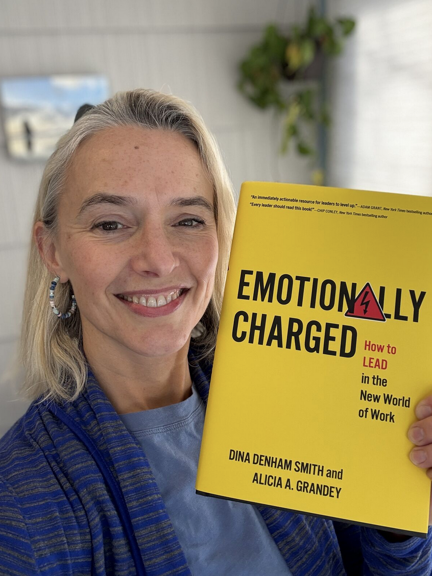 Alicia Grandey holds a copy of her book 
