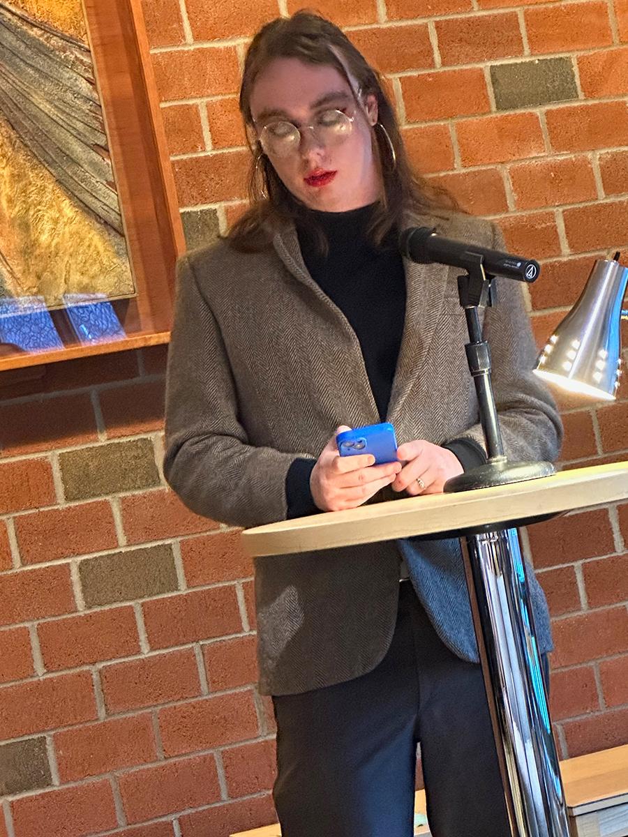 Student Ember Rose reads a poem
