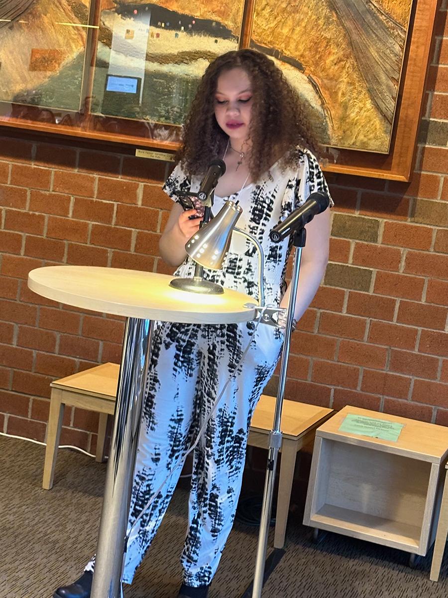 Student Emera Gregor reads an original short story