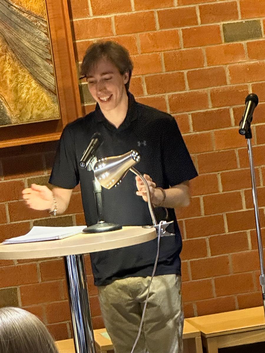 Student Patrick Galante reads an original poem.