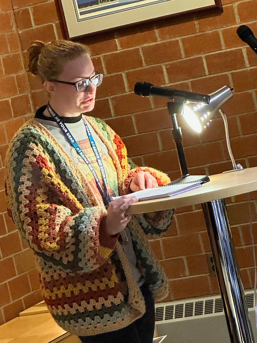 Student MiKayla Kelly reads an original poem.