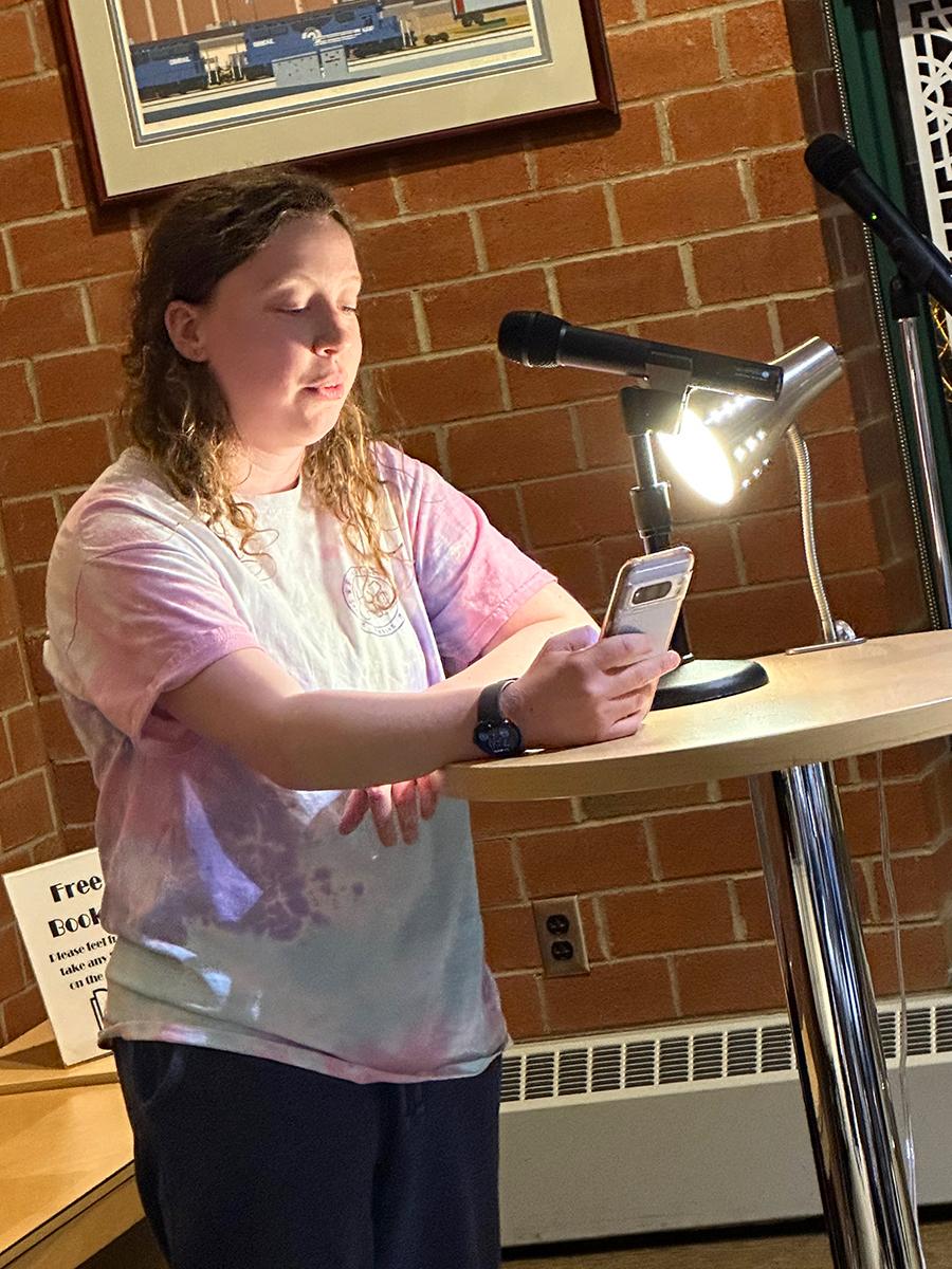 Student Bailee Seymour reads an original poem.