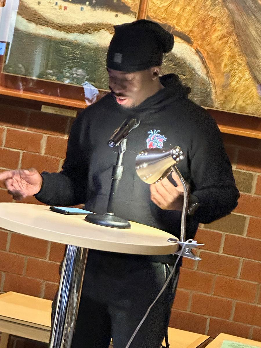 Student Darson Antoine reads an original poem.