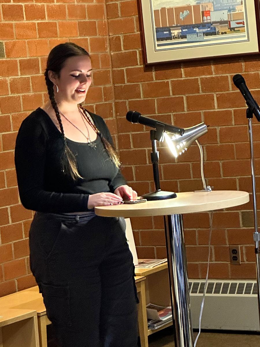 Student Piper Maxwell reads an original poem.