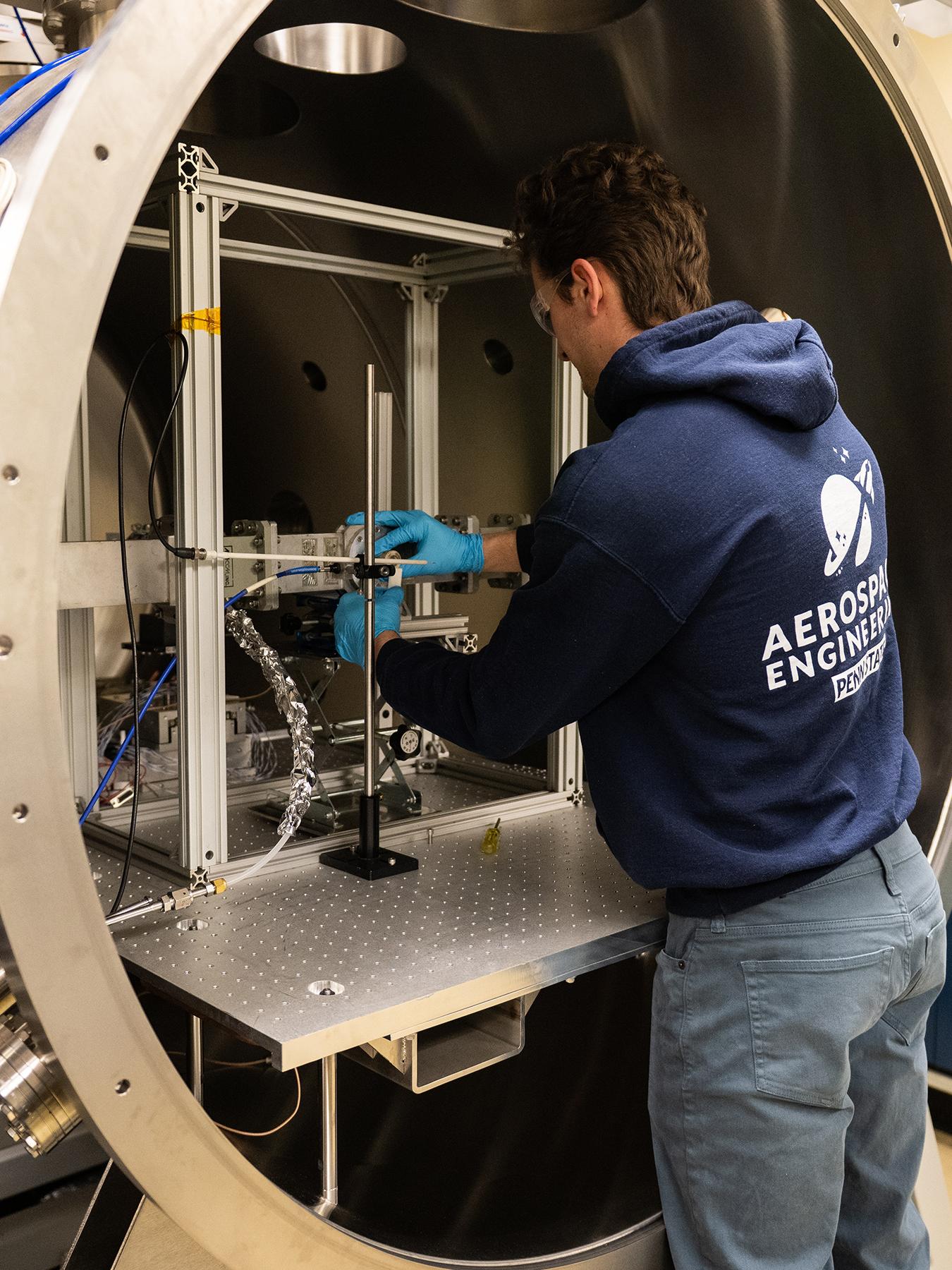 Person in front of a vacuum chamber